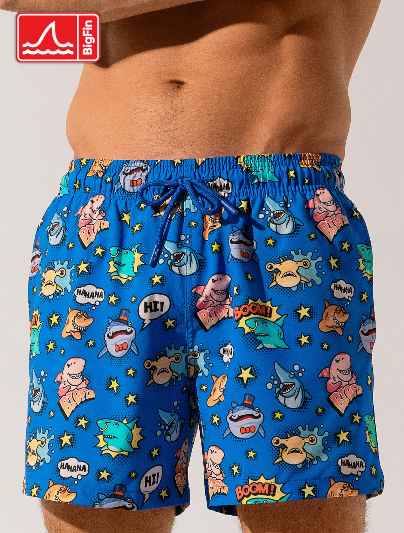 Blue swim shorts with cartoon character pattern on a plain background