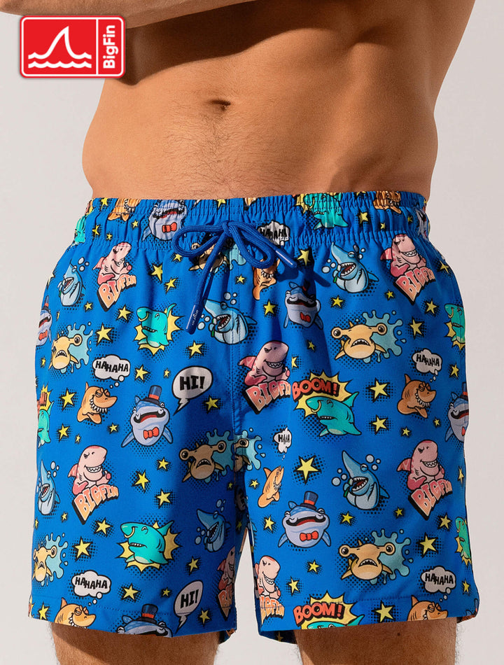 Blue swim shorts with cartoon character pattern on a plain background